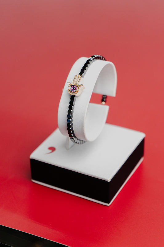 Bracciale Roberto Demeglio in ceramica nera satinata e simbolo mano in rubini, diamanti neri, bianchi e brown su oro rosa